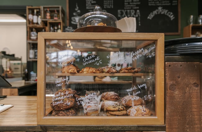 Cabinet food behind glass on a counter.