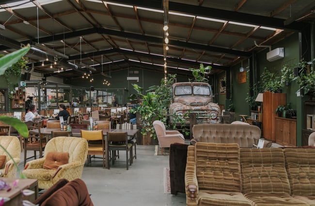 A large cafe decorated with vintage furniture.
