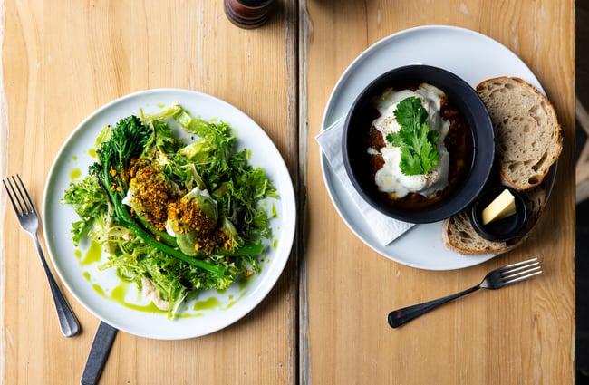 Two plates of food on a table.
