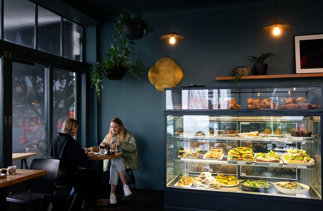 Two women sitting at a cafe table.