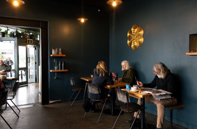 Customers dining inside a cafe painted blue.