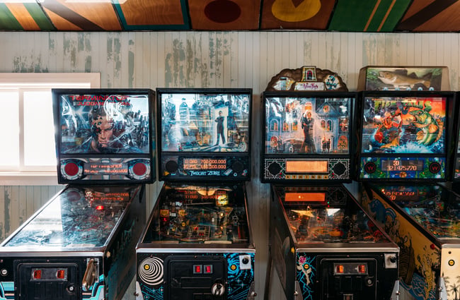 The retro pinball machines against the back wall of Seashore Cabaret.