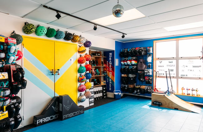 Wall of helmets and skate ramp at Seaside Skates.