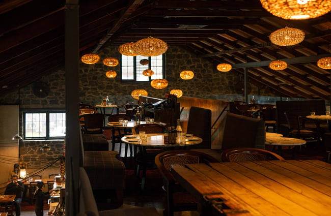 Dining upstairs on a mezzanine floor inside a dimly lit restaurant.