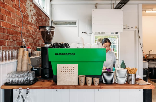 Barista behind the coffee machine at Shelly Bay Baker on Karori Road.
