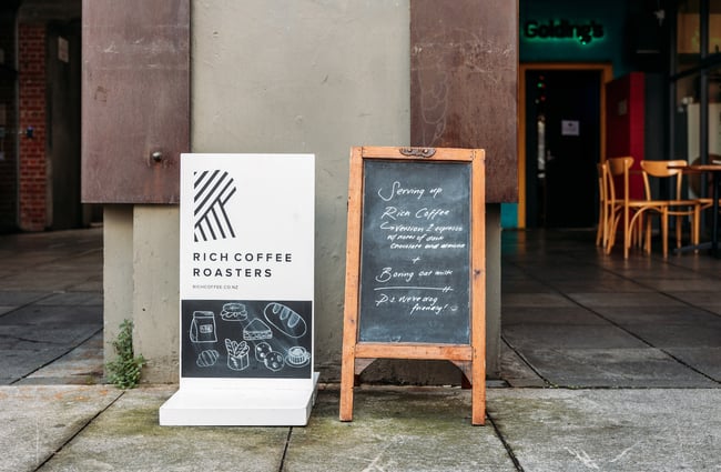Coffee and blackboard sign on the laneway in front of Shelly Bay Baker on Leeds Street