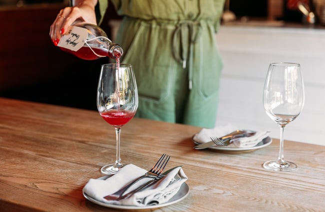 Rose wine being poured into a glass.