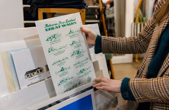 Customer holding an artwork print at Shopology.