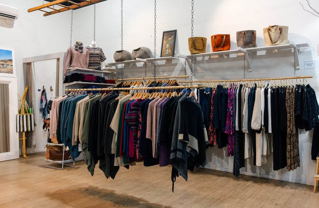 Racks of clothing in the middle of the shop floor at Shopology.