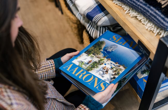 Customer holding a book at Shopology.