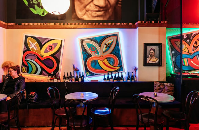 Colourful works of art on a wall inside Siduri bar.