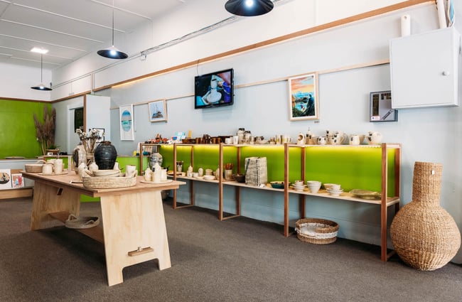 Interior of ceramics store with neon green feature walls