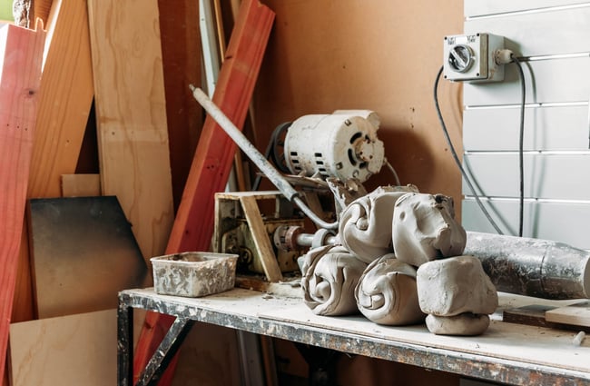 Close up of clay on workshop bench in a pottery studio