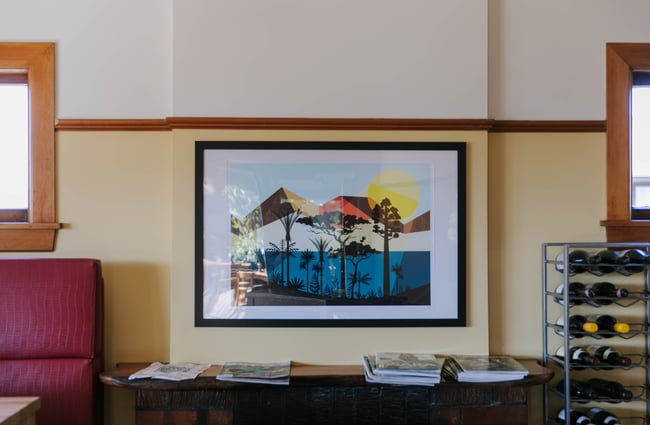 Colourful framed artwork on the wall.