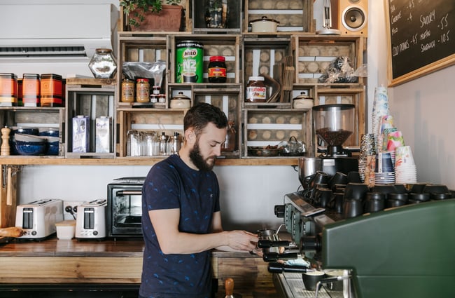 Barista making a shot of coffee at Six Ounces.