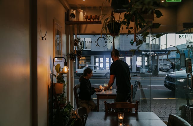 Wine being served to a table at Six Ounces, Christchurch.