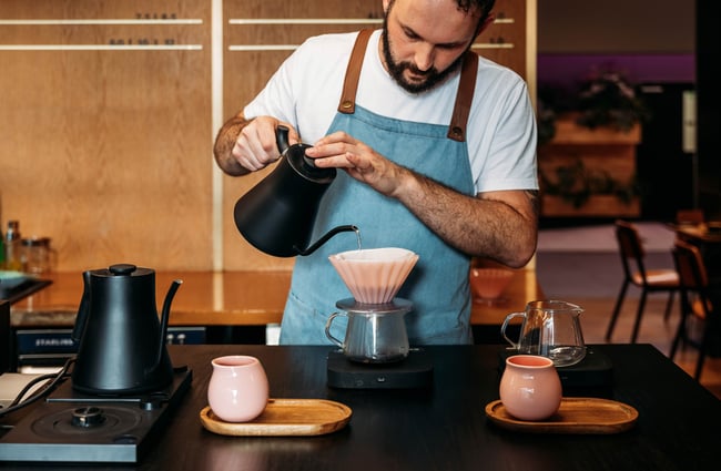 Barista making a pourover coffee at Sketchbook Coffee.