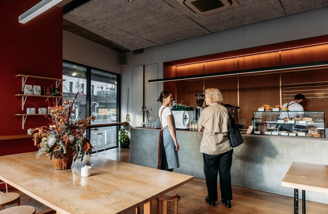 Barista talking with a customer at Sketchbook Coffee.