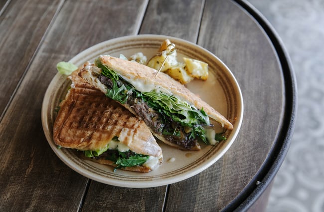 Toasted sandwich on a plate at Slam Club.