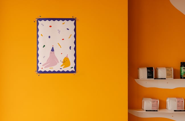 A work of art on a yellow wall.