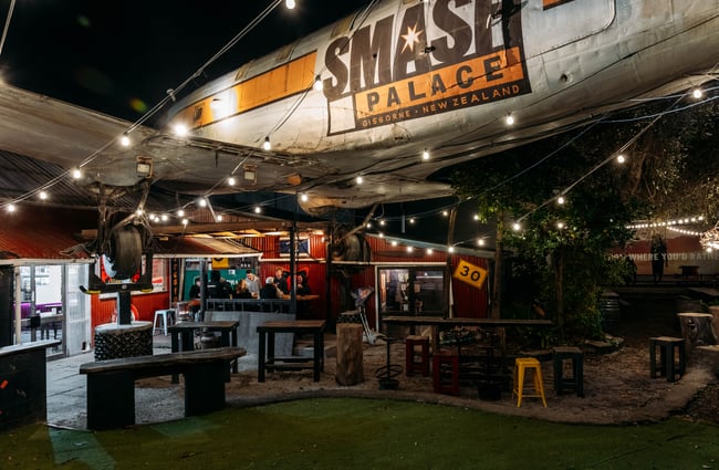 A darkly lit bar with a large blimp with the words 'Smash Palace' emblazoned across.