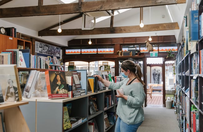 Woman browsing books at Smith's Bookshop, Christchurch.