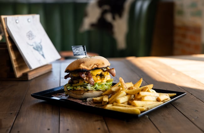Burger and chips on a plate.