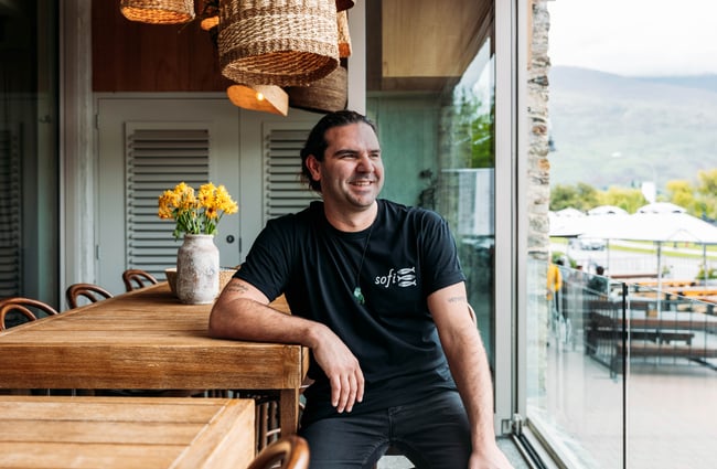 Chef sitting at a table at Sofi.