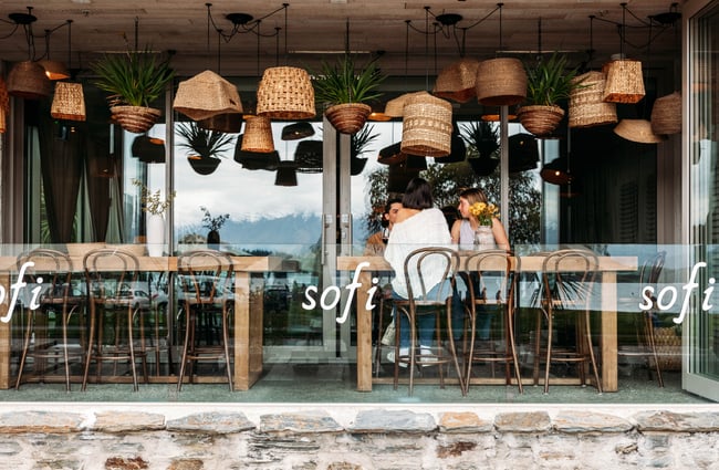 Customers sitting at a table on the balcony at Sofi.