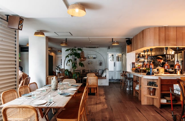 Dining table and view of the kitchen at Sofi.
