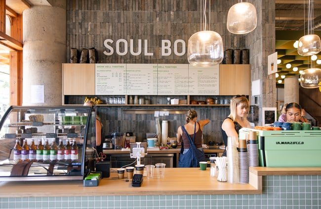 Staff member working behind a counter at Soul Boul in Hamilton.