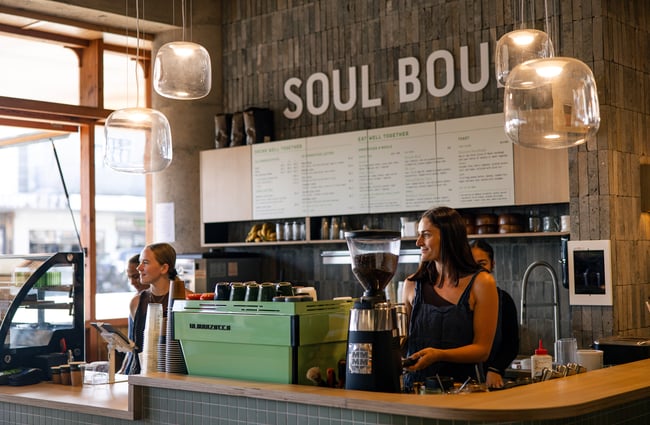 Staff members laughing behind the counter at Soul Boul in Hamilton.