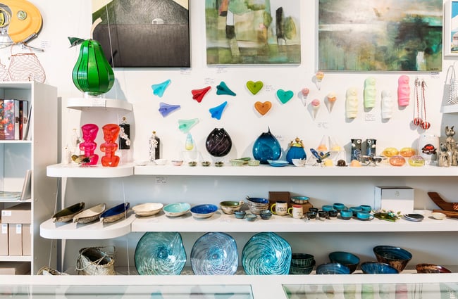 Smaller ceramic and glass objects on shelves at Soul Gallery.