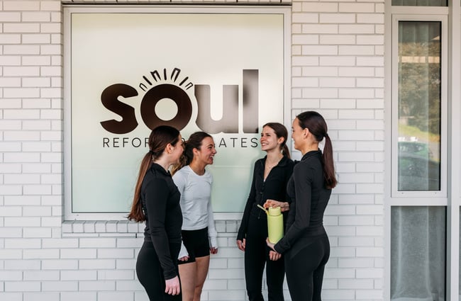 Clients standing outside Soul Pilates talking.
