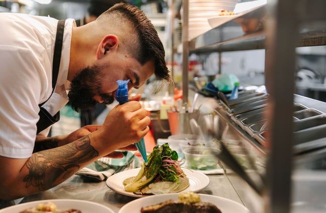 Chef preparing dish.