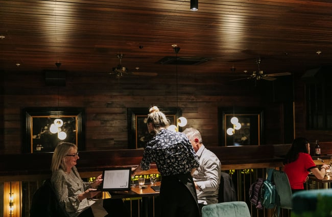 Waitress serving a table.