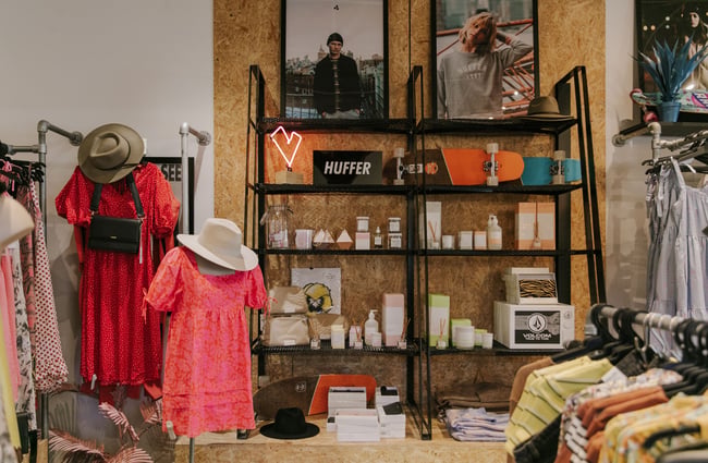 A brightly lit corner of Soul Surf and Skate Oamaru with clothes and beauty products on display.