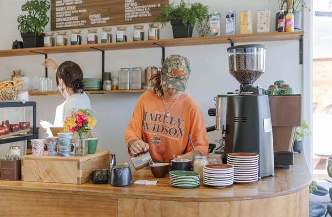 Barista pouring coffee at Soulful Coffee Diamond Harbour.