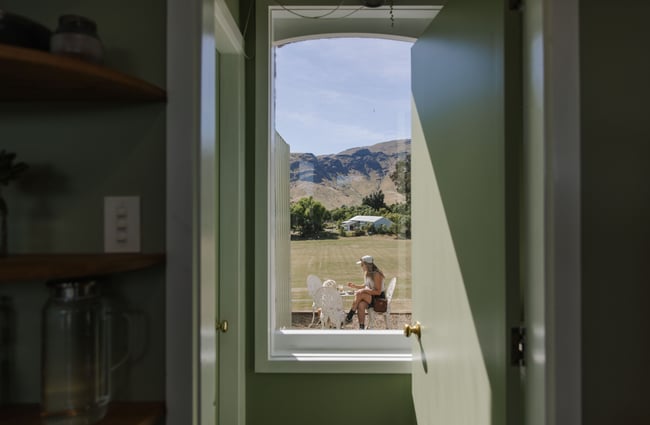 View through a doorway to a customer sitting outside at Soulful Coffee Diamond Harbour.