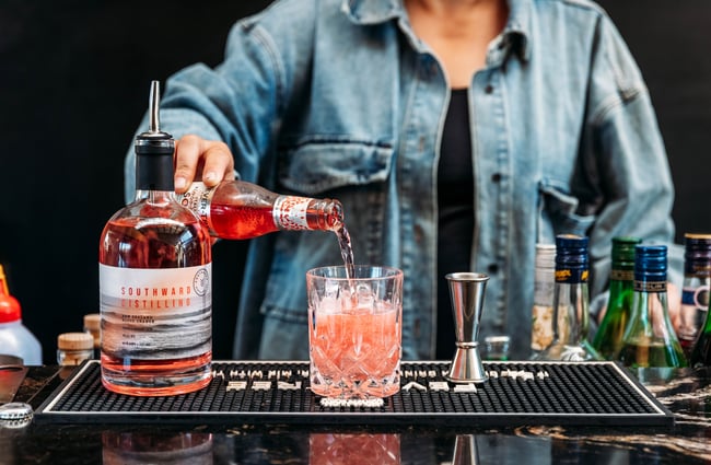 A cocktail being made on a counter.