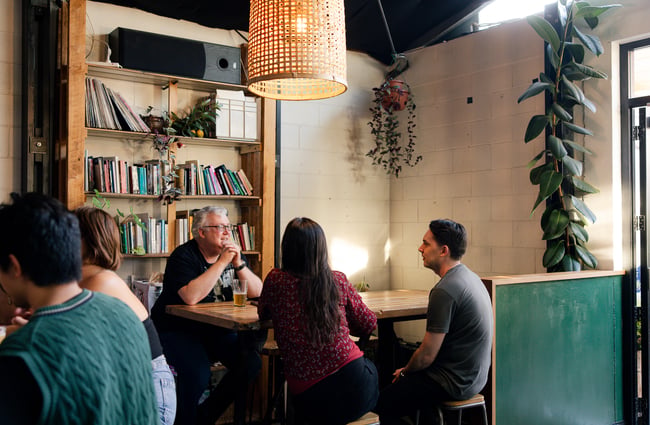 Customers at a table inside at Space Academy.