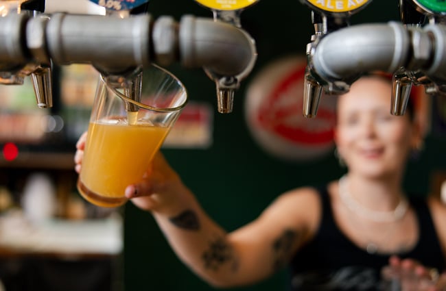 Bartender pouring a beer at Space Academy.