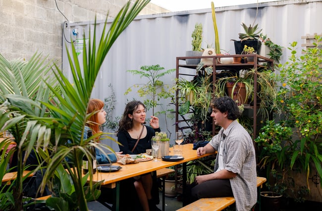 Customers enjoying the outdoor courtyard at Space Academy.