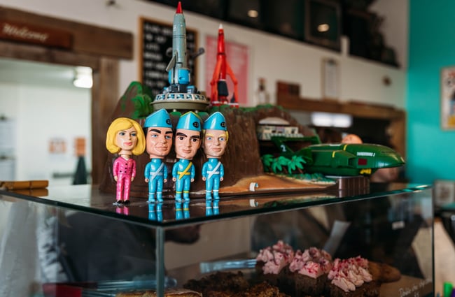 Thunderbird figurines and toy spaceships on the counter at Space Cadet, Hamilton.