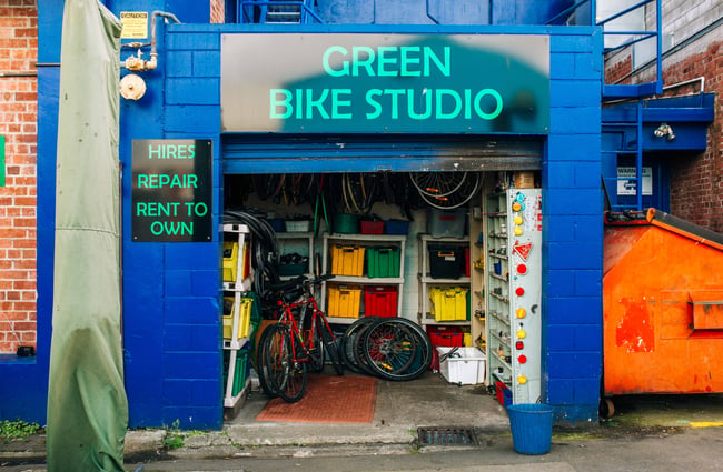 Close up of the bike shop entrance with a blue brick.
