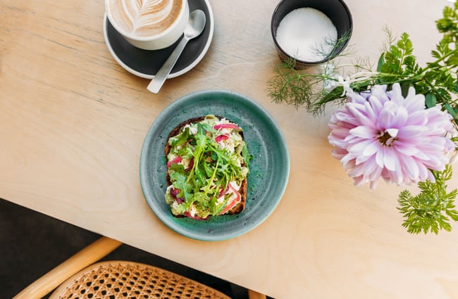 A flatlay of toast with lots of toppings on a table.