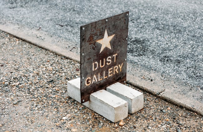 A 'Dust Gallery' footpath sign.