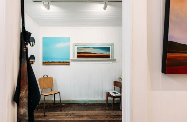 Works of art on display on white walls.