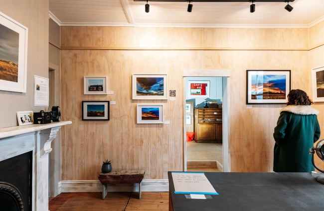 A woman browsing art inside Stardust Gallery Naseby Central Otago.