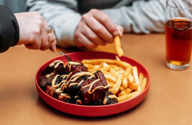 A plate of chips and meat.